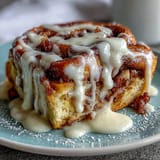 Decadent breakfast casserole with cinnamon sugar swirls and rich cream cheese glaze, perfect for brunch.  