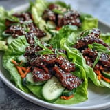 Flaky Korean BBQ beef wraps, bursting with fresh, spicy kimchi, perfect for lunch.