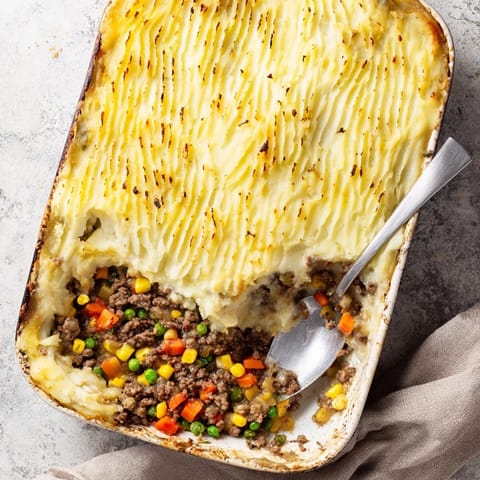 Golden brown Shepherd's Pie with creamy mashed potato ridges bubbling over a savory beef and vegetable filling.