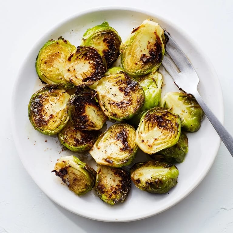 Close-up of Roasted Brussels Sprouts, showcasing their nutty flavor and tender centers after roasting at 425°F.