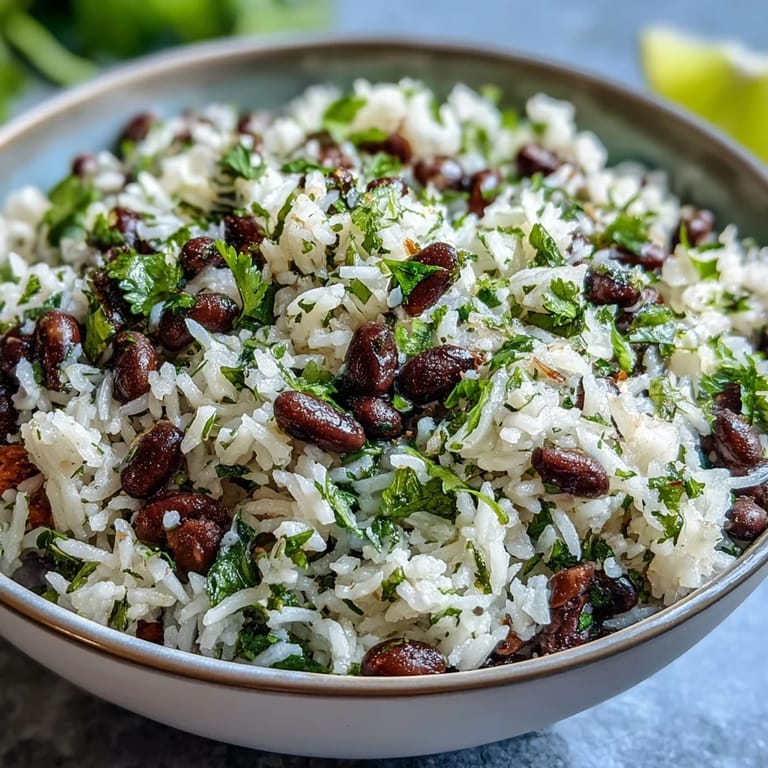 Vibrant coconut lime rice bursting with plump black beans and fresh cilantro garnish.