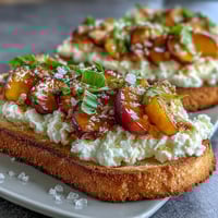 Creamy burrata and juicy honey-glazed peaches atop rustic sourdough toast, perfect for spring brunch.  